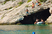 Jump from above the cave at Porat bay, in front of Kod Jakse beach restaurant